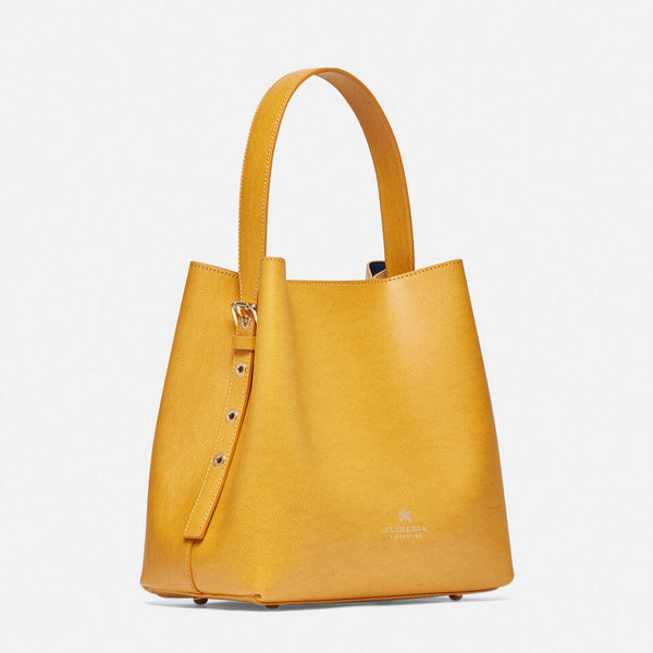 Un Secchiello Della Collezione Alice di colore Giallo sobrio ed elegante. Caratterizzato da uno spallaccio regolabile in altezza, chiusura a bottone e tasca a chiusura zip interna.